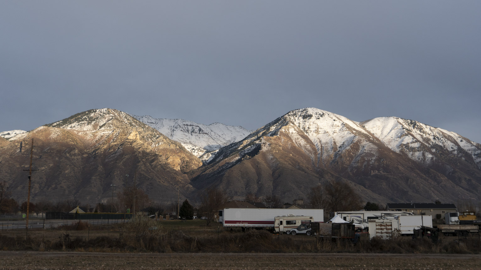 The mountains lit by a strip of sunlight comign through the clouds